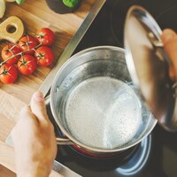 Process of cooking. Lifestyle background. Man checking boiling water in cooking pot. Closeup. Horizontal.